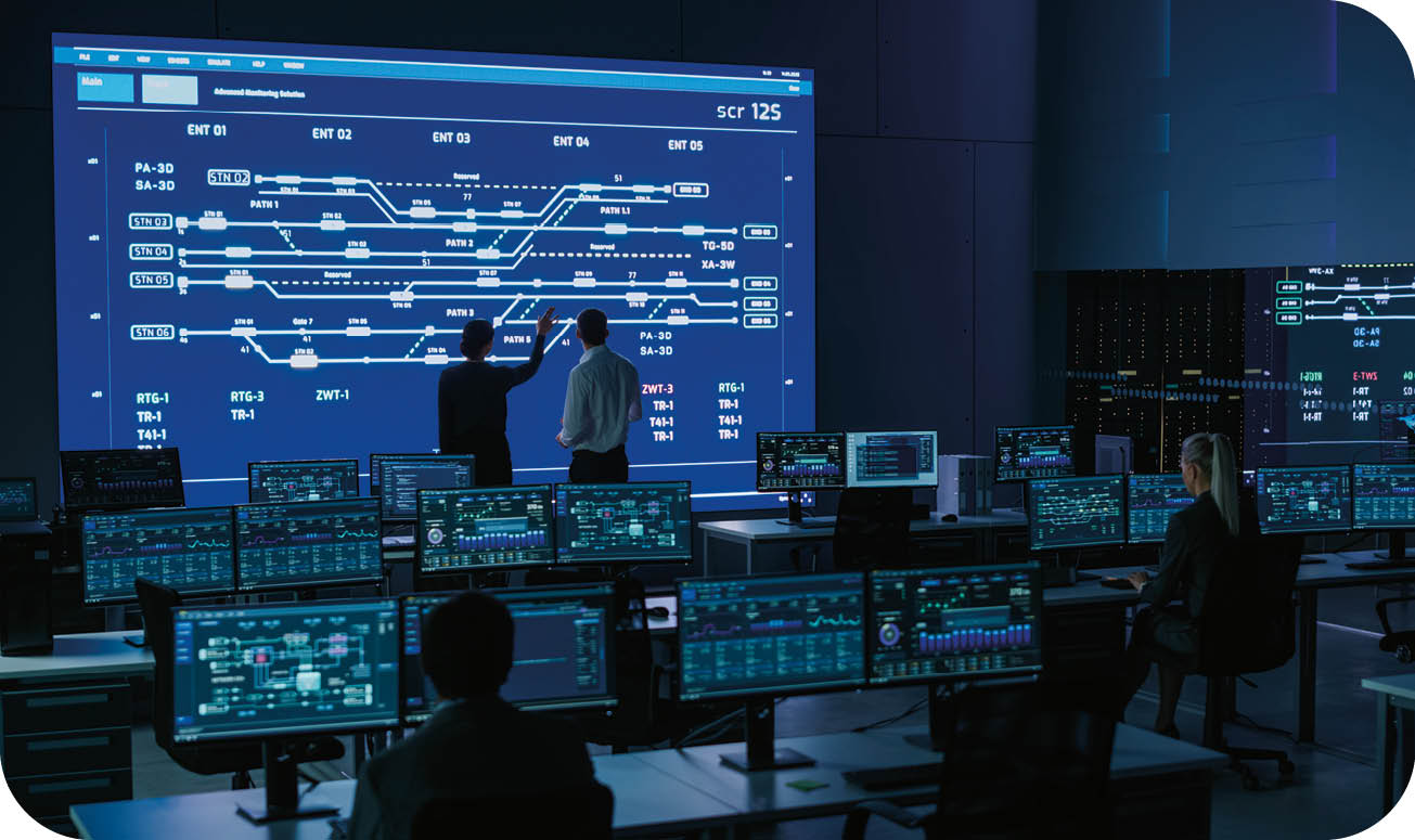 Project Manager and Computer Science Engineer Talking while Using Big Screen Display Showing Infrastructure Infographics and Data.Telecommunications Company System Control and Monitoring Room